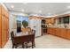 Well-maintained kitchen with ample cabinet space, appliances, and breakfast nook at 12906 Cherry Way, Thornton, CO 80241