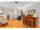 A view of the living room with a bar, hardwood floors and two sitting chairs at 12906 Cherry Way, Thornton, CO 80241