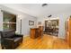Open-concept living space with hardwood floors and a unique bar area at 12906 Cherry Way, Thornton, CO 80241