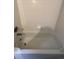 Bathtub in the bathroom with shower head and white tiles at 1129 S Duquesne Cir, Aurora, CO 80018