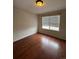 Bedroom featuring a window and wood laminate flooring at 1129 S Duquesne Cir, Aurora, CO 80018