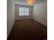 Bedroom featuring a window and neutral colored carpet at 1129 S Duquesne Cir, Aurora, CO 80018