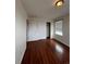 Bedroom featuring wood laminate flooring, a window, and closet at 1129 S Duquesne Cir, Aurora, CO 80018