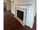 Cozy fireplace with elegant mantel, built-in shelving, and hardwood flooring, perfect for relaxing evenings at 1129 S Duquesne Cir, Aurora, CO 80018