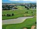 Panoramic aerial view featuring a golf course, pond, and surrounding homes at 3751 W 136Th Ave # S3, Broomfield, CO 80023