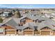 Aerial view of neighborhood showing attached garages and mountain backdrop at 3751 W 136Th Ave # S3, Broomfield, CO 80023