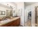 Spacious bathroom featuring double sinks, walk-in shower, and a walk-in closet at 3751 W 136Th Ave # S3, Broomfield, CO 80023