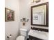 Powder room with framed mirror, artwork, and modern fixtures at 3751 W 136Th Ave # S3, Broomfield, CO 80023