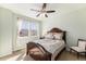 Bedroom with a decorative wooden bed frame and bright natural light at 3751 W 136Th Ave # S3, Broomfield, CO 80023