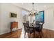 Elegant dining room with a dark wood table, chandelier lighting, and natural light from sliding glass doors at 3751 W 136Th Ave # S3, Broomfield, CO 80023