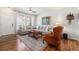Comfortable living room with hardwood floors, a large gray sofa, and a classic leather armchair at 3751 W 136Th Ave # S3, Broomfield, CO 80023