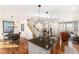 Open floorplan with a modern kitchen island, staircase, dining area and a view into the cozy living space at 3751 W 136Th Ave # S3, Broomfield, CO 80023