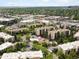 A beautiful aerial view of the condominium complex showcasing the lush green trees and manicured landscaping at 3470 S Poplar St. # 110, Denver, CO 80224