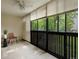 Bright balcony with neutral walls and views of mature trees at 3470 S Poplar St. # 110, Denver, CO 80224