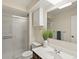 Bright bathroom with modern vanity, large mirror, cabinet, and walk-in shower at 3470 S Poplar St. # 110, Denver, CO 80224