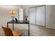 Bedroom featuring a desk, lamp, closet, and a soft carpet at 3470 S Poplar St. # 110, Denver, CO 80224