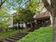 Exterior shot with landscaped entry, stairs leading to the front doors, with lovely mature trees at 3470 S Poplar St. # 110, Denver, CO 80224