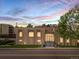 Exterior of building featuring well-lit entrance, steps and windows with colorful sky at sunset at 3470 S Poplar St. # 110, Denver, CO 80224