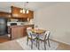 Dining area with a wood table and seating next to the kitchen at 3470 S Poplar St. # 110, Denver, CO 80224