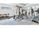 Fully equipped gym with weightlifting machines, mirrors, and carpet flooring, ideal for fitness enthusiasts at 3470 S Poplar St. # 110, Denver, CO 80224