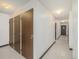 Hallway with storage lockers and tile flooring, providing practical storage solutions and easy maintenance at 3470 S Poplar St. # 110, Denver, CO 80224