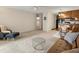 Open-concept living room with kitchen and dining area, featuring neutral carpeting and furnishings at 3470 S Poplar St. # 110, Denver, CO 80224