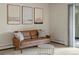 Comfortable living room with neutral walls and a stylish brown sofa and round metal table at 3470 S Poplar St. # 110, Denver, CO 80224