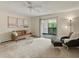 Bright living room featuring a cozy couch, soft carpet, and sliding glass doors to outdoor space at 3470 S Poplar St. # 110, Denver, CO 80224