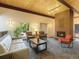 Inviting living room with a brick fireplace and wood-paneled ceiling, offering a cozy and stylish space at 3470 S Poplar St. # 110, Denver, CO 80224