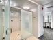 Shower room with frosted glass doors and tiled walls, offering a clean and private bathing space at 3470 S Poplar St. # 110, Denver, CO 80224