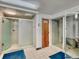 Shower room with frosted glass doors, tiled walls, and floors, ensuring privacy and easy maintenance at 3470 S Poplar St. # 110, Denver, CO 80224