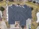 Aerial view of a large home with a complex roofline, a driveway, and surrounding landscaping in winter at 7560 S Biloxi Ct, Aurora, CO 80016