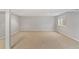 Open basement area featuring neutral walls and carpet with a window allowing in natural light at 7560 S Biloxi Ct, Aurora, CO 80016