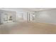 Spacious finished basement with neutral carpet and access to the outside at 7560 S Biloxi Ct, Aurora, CO 80016
