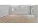 Finished basement featuring neutral walls, carpet, and access to outside at 7560 S Biloxi Ct, Aurora, CO 80016