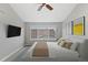 Bedroom features a ceiling fan, window view of neighborhood, and neutral décor at 7560 S Biloxi Ct, Aurora, CO 80016