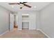 Empty bedroom with carpet flooring, ceiling fan, an open closet and access to the hallway at 7560 S Biloxi Ct, Aurora, CO 80016