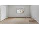 Bright bedroom featuring neutral walls, plush carpet, and natural light from a window at 7560 S Biloxi Ct, Aurora, CO 80016