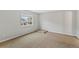 Neutral bedroom with plush carpeting, a single window, and an elevated platform in the corner at 7560 S Biloxi Ct, Aurora, CO 80016