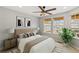Cozy bedroom with natural light, ceiling fan, stylish decor, and carpeted floors at 7560 S Biloxi Ct, Aurora, CO 80016
