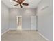 Spacious bedroom boasts ample natural light, plush carpeting, and ceiling fan at 7560 S Biloxi Ct, Aurora, CO 80016