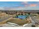 Aerial view of neighborhood tennis and pickleball courts next to homes in a well-planned community at 7560 S Biloxi Ct, Aurora, CO 80016