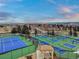 Scenic view of neighborhood tennis and pickleball courts with well-maintained landscaping at 7560 S Biloxi Ct, Aurora, CO 80016