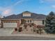 Charming ranch-style home featuring a brick facade, attached garage, and landscaped front yard at 7560 S Biloxi Ct, Aurora, CO 80016