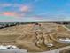 Expansive aerial view of a golf course with undulating greens, manicured bunkers, and winding cart paths at 7560 S Biloxi Ct, Aurora, CO 80016