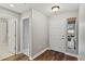 Hallway with access to a bathroom, bedrooms, and front door at 7560 S Biloxi Ct, Aurora, CO 80016