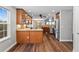 Well-lit kitchen featuring granite countertops, stainless steel appliances, and wood flooring at 7560 S Biloxi Ct, Aurora, CO 80016