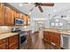 Spacious kitchen with stainless steel appliances, granite countertops and a view to the backyard deck at 7560 S Biloxi Ct, Aurora, CO 80016