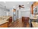 Open kitchen design with granite countertops, stainless steel appliances, wood floors and ceiling fan at 7560 S Biloxi Ct, Aurora, CO 80016