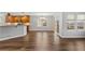 Living room features hardwood floors, natural light, and access to the kitchen at 7560 S Biloxi Ct, Aurora, CO 80016